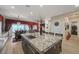 Bright, open kitchen with stainless steel sink in the center island, and dining area at 8 Reverie Heights Ave, Henderson, NV 89011