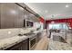 Modern kitchen featuring a granite countertop, stainless steel appliances, and hardwood floors at 8 Reverie Heights Ave, Henderson, NV 89011