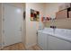 The laundry room features a washer, dryer, and overhead shelf storage at 8 Reverie Heights Ave, Henderson, NV 89011