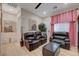 Inviting living room with brown leather seating, elegant decor, and light wood flooring, creating a cozy and stylish atmosphere at 8 Reverie Heights Ave, Henderson, NV 89011