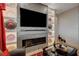 Inviting living room featuring a fireplace, tv, and decorative wall plates at 8 Reverie Heights Ave, Henderson, NV 89011