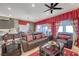 The inviting living room features plush seating, a ceiling fan, and seamless access to the kitchen at 8 Reverie Heights Ave, Henderson, NV 89011