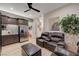 Cozy living room features brown leather seating, recessed lighting, a ceiling fan, wet bar, and a decorative tree at 8 Reverie Heights Ave, Henderson, NV 89011