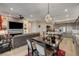 Bright and airy living area flows into kitchen and dining, complete with entertainment center and fireplace at 8 Reverie Heights Ave, Henderson, NV 89011