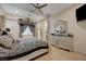 Luxurious main bedroom suite with ornate canopy bed, mirrored dresser, and ceiling fan at 8 Reverie Heights Ave, Henderson, NV 89011