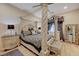 Elegant main bedroom showcasing a four-poster bed, stylish decor, and ensuite bathroom at 8 Reverie Heights Ave, Henderson, NV 89011