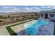 Kidney shaped pool with an artificial grass surround and views of the lake and mountains at 8 Reverie Heights Ave, Henderson, NV 89011