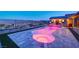 Beautiful backyard pool with multicolored lighting and a view of the Las Vegas valley at 8 Reverie Heights Ave, Henderson, NV 89011