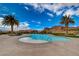 Lagoon-style pool surrounded by palm trees with lounge chairs nearby and mountain views at 8 Reverie Heights Ave, Henderson, NV 89011