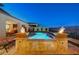 Stunning backyard pool with illuminated fountains and fire features overlooking the cityscape at 8 Reverie Heights Ave, Henderson, NV 89011