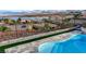 Partial view of kidney shaped pool with a safety fence and views of the lake and mountains at 8 Reverie Heights Ave, Henderson, NV 89011