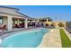 Inviting backyard pool with spa, covered patio, and travertine tile surround at 8 Reverie Heights Ave, Henderson, NV 89011