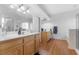 Bathroom featuring a dual sink vanity, laminate floors, and ample counter space at 8036 Eurostar St, Las Vegas, NV 89131