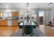 Dining room featuring wood floors, a modern light fixture, and a view of the backyard at 8036 Eurostar St, Las Vegas, NV 89131