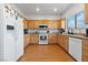 Bright kitchen featuring wood cabinets, white appliances, and lots of countertop space at 8036 Eurostar St, Las Vegas, NV 89131