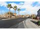 A charming street view featuring desert landscaping and a gated entrance to the community at 8036 Eurostar St, Las Vegas, NV 89131