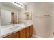 Bathroom features double sinks with wood cabinets and large mirror at 8045 Sundance Valley Dr, Las Vegas, NV 89178