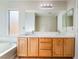 Bright bathroom features a double sink vanity, large mirror, and separate tub at 8045 Sundance Valley Dr, Las Vegas, NV 89178