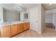 Bathroom featuring a double sink vanity, large mirror, and tile flooring at 8045 Sundance Valley Dr, Las Vegas, NV 89178