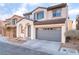 Charming two-story home with a two-car garage and desert landscaping in a residential neighborhood at 8045 Sundance Valley Dr, Las Vegas, NV 89178