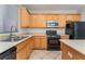 A kitchen featuring stainless steel appliances, wooden cabinets, and tile floors at 8045 Sundance Valley Dr, Las Vegas, NV 89178