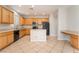 Spacious kitchen featuring wood cabinets, tile floors, island, and modern appliances at 8045 Sundance Valley Dr, Las Vegas, NV 89178