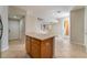 View from kitchen island toward open floorplan featuring tile flooring and staircase at 8045 Sundance Valley Dr, Las Vegas, NV 89178