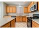 Kitchen featuring a stainless steel microwave, gas range, and tile flooring at 8045 Sundance Valley Dr, Las Vegas, NV 89178