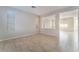 Open living room featuring tile floors, neutral walls, and large windows for natural light at 8045 Sundance Valley Dr, Las Vegas, NV 89178