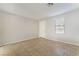 A spacious room featuring tile floors, neutral walls, a ceiling fan, and natural light at 8045 Sundance Valley Dr, Las Vegas, NV 89178