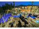 Expansive backyard featuring a custom pool with rock features and lush landscaping on the grounds at 8280 Via Olivero Ave, Las Vegas, NV 89117