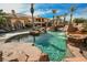 Expansive backyard with a custom pool, rock waterfalls, and desert landscape perfect for entertaining at 8280 Via Olivero Ave, Las Vegas, NV 89117