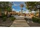 Expansive backyard featuring a custom pool with rock waterfall, lush landscaping, and a patio for outdoor entertaining at 8280 Via Olivero Ave, Las Vegas, NV 89117