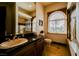 Bright bathroom with a granite countertop, framed mirror, and tiled shower at 8280 Via Olivero Ave, Las Vegas, NV 89117