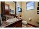 Traditional half bathroom with marble countertop vanity and decorative mirror at 8280 Via Olivero Ave, Las Vegas, NV 89117