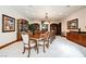 Formal dining room boasts a large wood table, carpeted floors, and ornate decor at 8280 Via Olivero Ave, Las Vegas, NV 89117