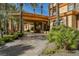 Luxury home showcasing a stately porte cochere, lush landscaping, and an inviting entrance at 8280 Via Olivero Ave, Las Vegas, NV 89117