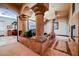 Grand foyer with stone pillars, arched doorways, and decorative tile flooring creates an impressive entry at 8280 Via Olivero Ave, Las Vegas, NV 89117