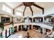 This grand foyer features soaring ceilings, exposed wood beams, and a dazzling chandelier at 8280 Via Olivero Ave, Las Vegas, NV 89117