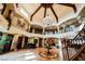 Expansive foyer showcasing high ceilings, decorative chandelier, and a second-story view with iron railing at 8280 Via Olivero Ave, Las Vegas, NV 89117