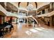 Grand foyer with soaring ceilings, elegant chandelier, and winding staircase, creating a luxurious entrance at 8280 Via Olivero Ave, Las Vegas, NV 89117