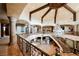 A large entryway showcases wood-beamed ceilings, stone floors and an ornate railing at 8280 Via Olivero Ave, Las Vegas, NV 89117