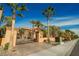 Gated entrance to property surrounded by lush, mature landscaping and a paved driveway at 8280 Via Olivero Ave, Las Vegas, NV 89117