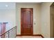 Hallway featuring dark wood door with bronze hardware against neutral colored walls at 8280 Via Olivero Ave, Las Vegas, NV 89117