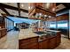 Gourmet kitchen featuring a large center island with stone counter tops and stainless steel appliances at 8280 Via Olivero Ave, Las Vegas, NV 89117