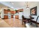 Well-lit kitchen with wooden cabinets, updated appliances, and a dining area for casual meals at 8280 Via Olivero Ave, Las Vegas, NV 89117