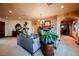 Cozy living room featuring hardwood floors, a stone fireplace and a comfortable couch at 8280 Via Olivero Ave, Las Vegas, NV 89117