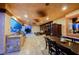 View of the covered patio with outdoor kitchen, dining table and comfortable seating area at 8280 Via Olivero Ave, Las Vegas, NV 89117