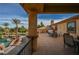 Upstairs outdoor patio space overlooks a luxurious pool with rock features and landscaping at 8280 Via Olivero Ave, Las Vegas, NV 89117