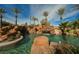 Tranquil pool area with rock details, flowing waterfalls, and beautifully maintained desert landscaping at 8280 Via Olivero Ave, Las Vegas, NV 89117